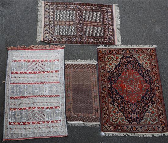A Caucasian red ground rug, largest 6ft 5in by 4ft 6in.